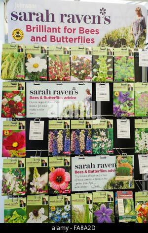 Packets of Johnsons Sarah Raven bee and butterfly friendly flower seeds for sale on a display stand in a garden centre Stock Photo