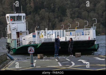 Cumbria, UK. 23rd December, 2015. The Windermere car ferry approaches some foreign tourists who are taking a selfie in front of the approaching vessel. Credit:  Michael Scott/Alamy Live News Stock Photo