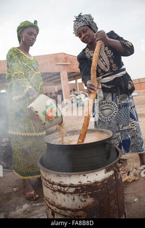 Rice is parboiled before being sold at a women's group processing center in Sourou Province, Burkina Faso. Stock Photo