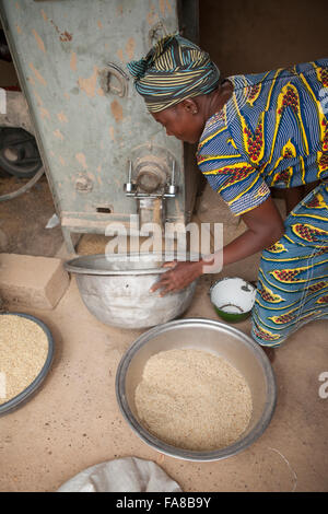 Rice is milled before being sold at a women's group processing center in Sourou Province, Burkina Faso. Stock Photo