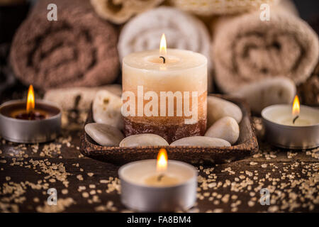 Spa and wellness setting with towels and candles Stock Photo