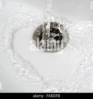 water flow into drain in bath,close up photo Stock Photo