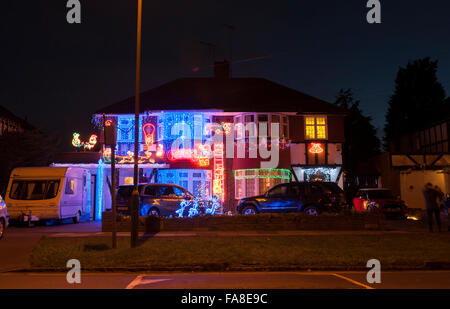 Lower Morden Lane, Surrey, UK. 23rd December, 2015. The residents of this suburban road decorate the exterior of their semi-detached houses with a riot of colourful christmas lights every year and accept donations from passing motorists and visiting locals to raise funds for local charities. Credit:  Malcolm Park editorial/Alamy Live News. Stock Photo