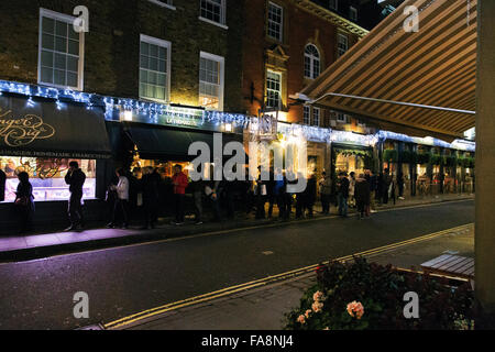 London, UK. 23rd December, 2015. Customers queue for Christmas orders. Ginger Pig butchers, Moxon street, Marylebone, London W1, England, UK Credit:  Keith Erskine/Alamy Live News Stock Photo