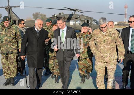 US Secretary of Defense Ashton Carter and Afghan Defense Minister Mohammed Masoom Stanekzai, left, walk with Commander of U.S. Forces Gen. John Campbell during a surprise visit to Forward Operating Base Fenty December 18, 2015 in Jalalabad, Afghanistan. Stock Photo