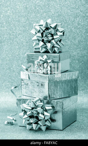 Gift box with ribbon on shiny background. Silver blue holidays decoration Stock Photo