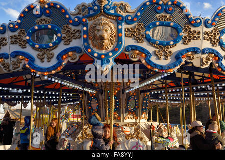 Children and parents on merry-go-round horses at Toronto Christmas Market Distillery District Stock Photo