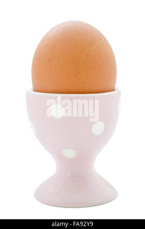 Brown egg in egg cup isolated on white background. Stock Photo