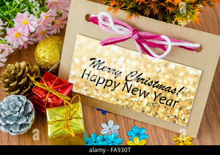 Christmas Greeting card ans happy new year with Christmas decorations with flower on wooden background. Stock Photo