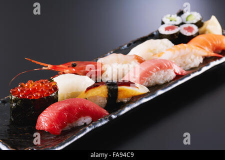 Sushi plate on black desk Stock Photo