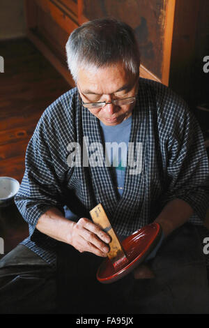 Japanese lacquer artisan working in the studio Stock Photo