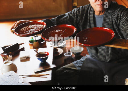 Japanese lacquer artisan working in the studio Stock Photo