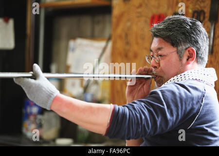 Japanese glass artisan working in the studio Stock Photo