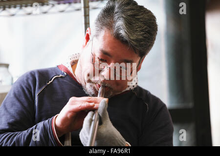 Japanese glass artisan working in the studio Stock Photo