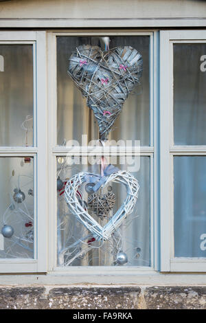 Hanging christmas hearts in a window. Stow on the Wold, Cotswolds, England Stock Photo