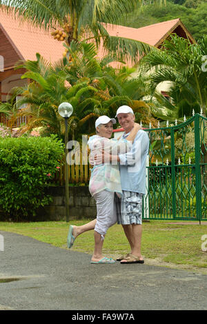 elderly couple standing embracing outdoors Stock Photo