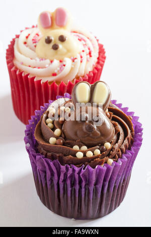 Easter cupcakes with white and milk chocolate bunny rabbits on isolated on white background Stock Photo
