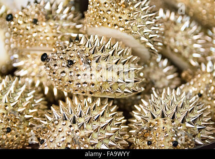 Background formed by golden hedgehogs to use as a paperweight. Stock Photo