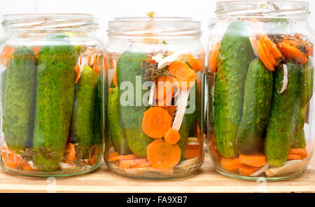 Pickled cucumbers in jars isolated on white Stock Photo