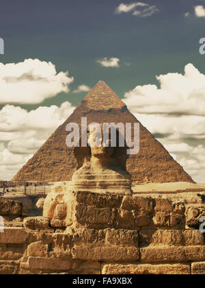 Beautiful profile of the Great Sphinx including pyramids of Menkaure and Khafre in the background on a clear sunny, blue sky day Stock Photo