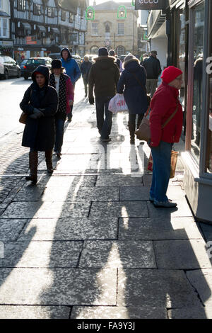 Stratford-upon-Avon, Warwickshire, UK. 24th Dec ember, 2015. Christmas Eve shoppers cast long shadows in High Street, Stratford-upon-Avon, UK. Credit:  Colin Underhill/Alamy Live News Stock Photo