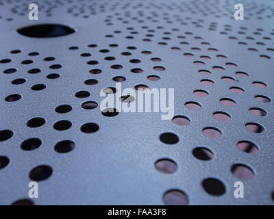 Metal table with holes and swirls design Stock Photo