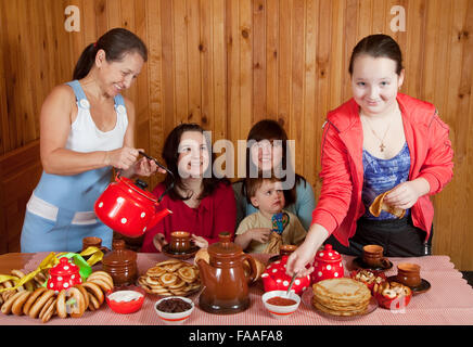 Happy family  drinking tea with russian traditional snack Stock Photo