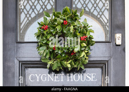 A colourful festive Christmas wreath on an English front door Stock Photo