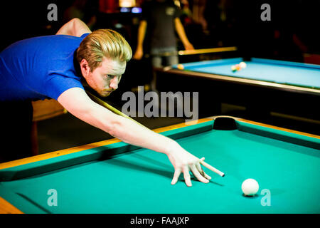 Young man playing snooker in the bar Stock Photo