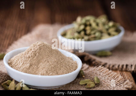 Portion of Cardamon Powder (close-up shot) on wooden background Stock Photo