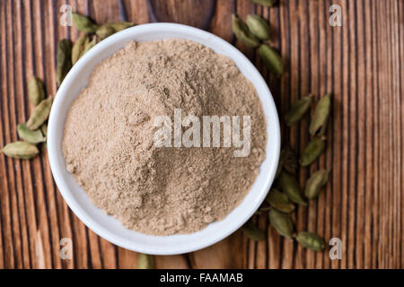 Portion of Cardamon Powder (close-up shot) on wooden background Stock Photo