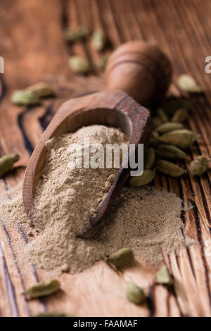 Portion of Cardamon Powder (close-up shot) on wooden background Stock Photo