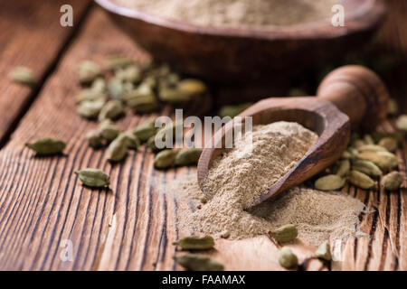 Portion of Cardamon Powder (close-up shot) on wooden background Stock Photo