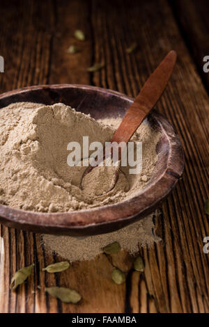 Portion of Cardamon Powder (close-up shot) on wooden background Stock Photo