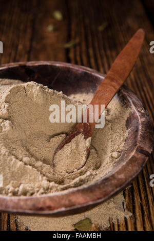 Portion of Cardamon Powder (close-up shot) on wooden background Stock Photo