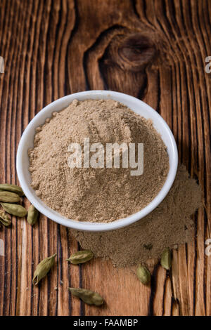 Portion of Cardamon Powder (close-up shot) on wooden background Stock Photo