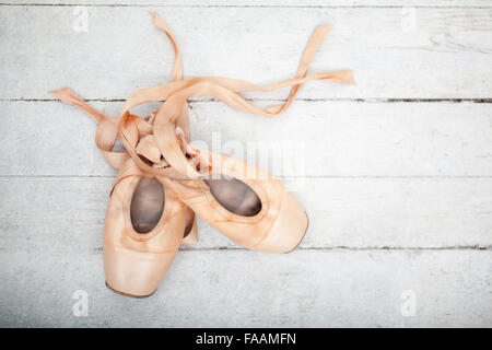 Pointe shoes on wooden background Stock Photo