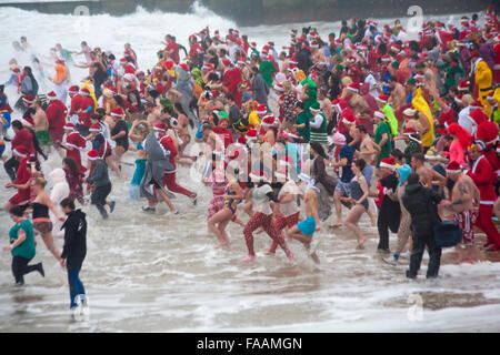 Bournemouth, Dorset, UK. 25th Dec, 2015. White Christmas Dip on Christmas Day. Brave volunteers plunge into the cold sea despite the wet misty breezy weather, for the 8th annual charity Christmas morning swim, dressed in fancy dress costumes and raising money for Macmillan Caring Locally at Christchurch, a Specialist Palliative Care Unit for patients in the local community. Hundreds took part in the event which has become a popular tradition for many before their lunch. Credit:  Carolyn Jenkins/Alamy Live News Stock Photo