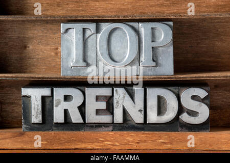 top trends phrase made from metallic letterpress type on wooden tray Stock Photo