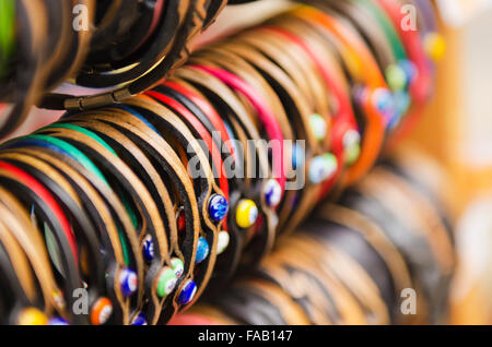 Leather handmade souvenir bracelets at the street market - shopping background Stock Photo