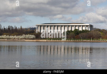 Iconic architecture of the National Library of Australia reflected in the waters of Lake Burley Griffin Canberra ACT Australia Stock Photo