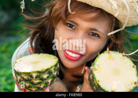 Young Asian woman with pineapple, on location, Cebu, Philippines Stock Photo