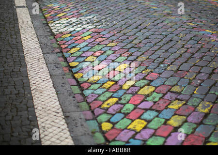 Stone pavement painted different bright colors. Stock Photo