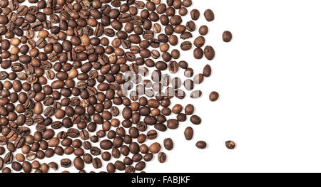 Layer of dark roasted coffee beans over white background Stock Photo