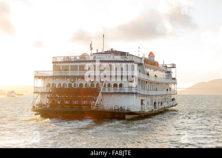 The historical San Francisco Belle paddlewheel boat in San Francisco Bay, California, USA in the pink light of sunset Stock Photo