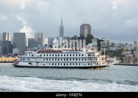 The San Francisco Belle paddlewheel boat in San Francisco Bay, California, USA with the city skyline and Fisherman's Wharf in the background Stock Photo