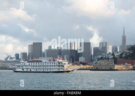 The San Francisco Belle paddlewheel boat in San Francisco Bay, California, USA with the city skyline and Fisherman's Wharf in the background Stock Photo