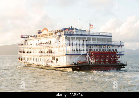 The historical San Francisco Belle paddlewheel boat in San Francisco Bay, California, USA in the pink light of sunset Stock Photo