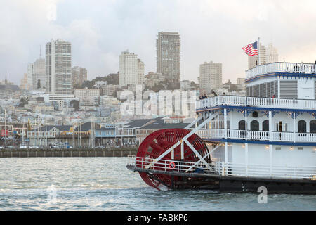 Detail of paddlewheel of the San Francisco Belle in San Francisco Bay, California, USA with the city skyline and Fisherman's Wharf in the background Stock Photo