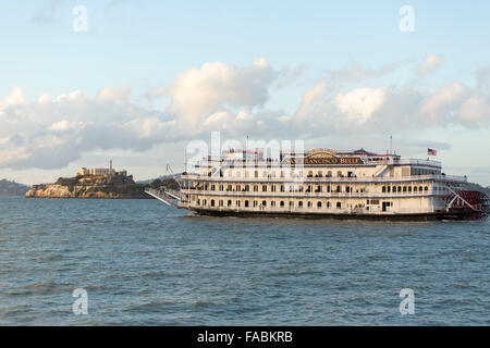 The historical San Francisco Belle paddlewheel boat in San Francisco Bay, California, USA approaching Alcatraz Island Stock Photo